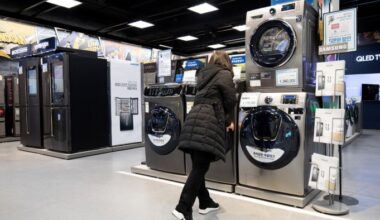 A woman looks at an appliance in a showroom