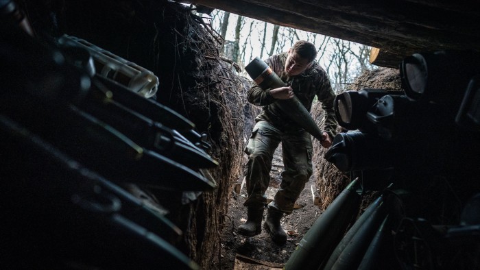 Ukrainian soldier carry ammunition for a howitzer donated by Poland in January 2025