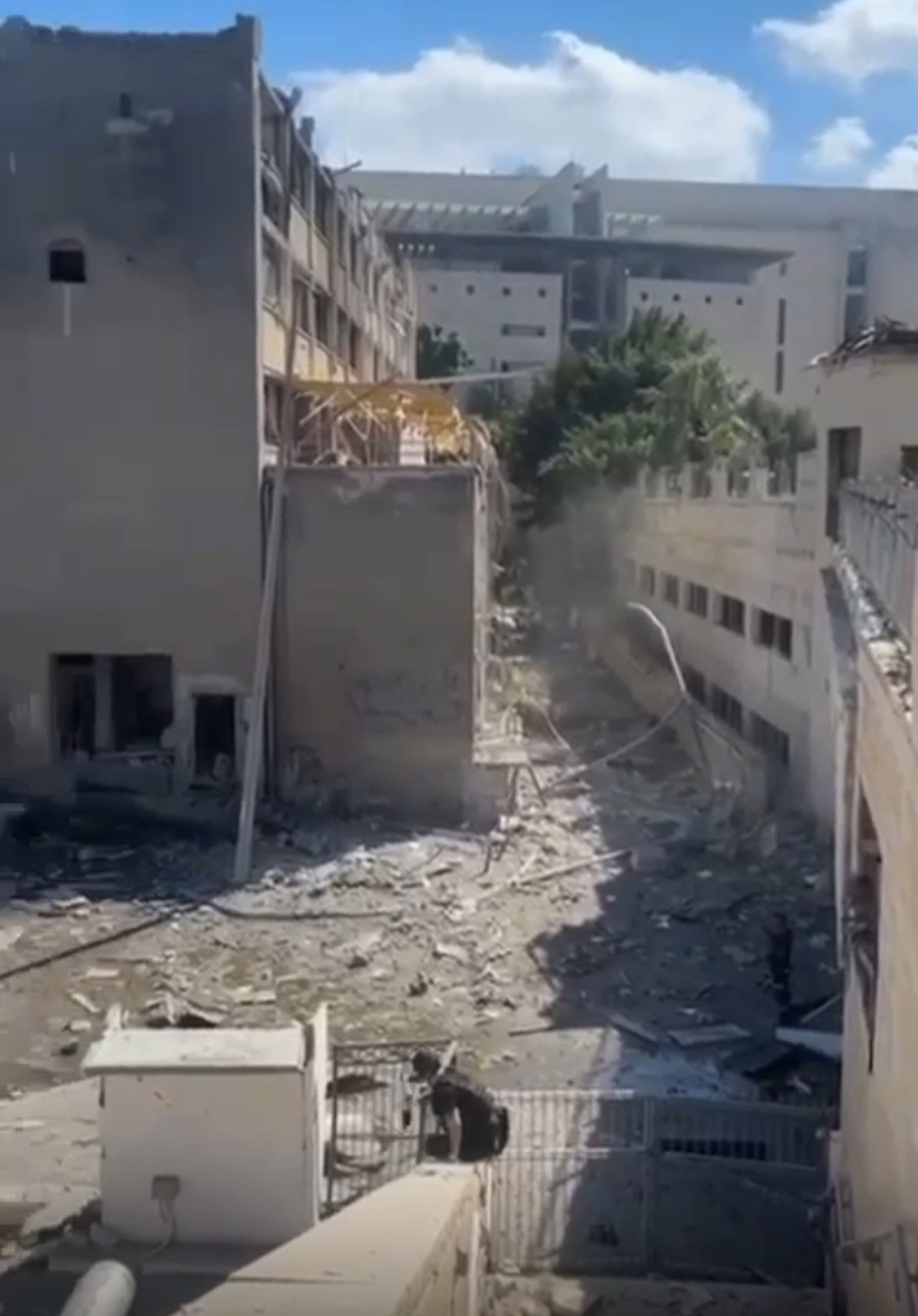 Part of a building, showing serious damage.