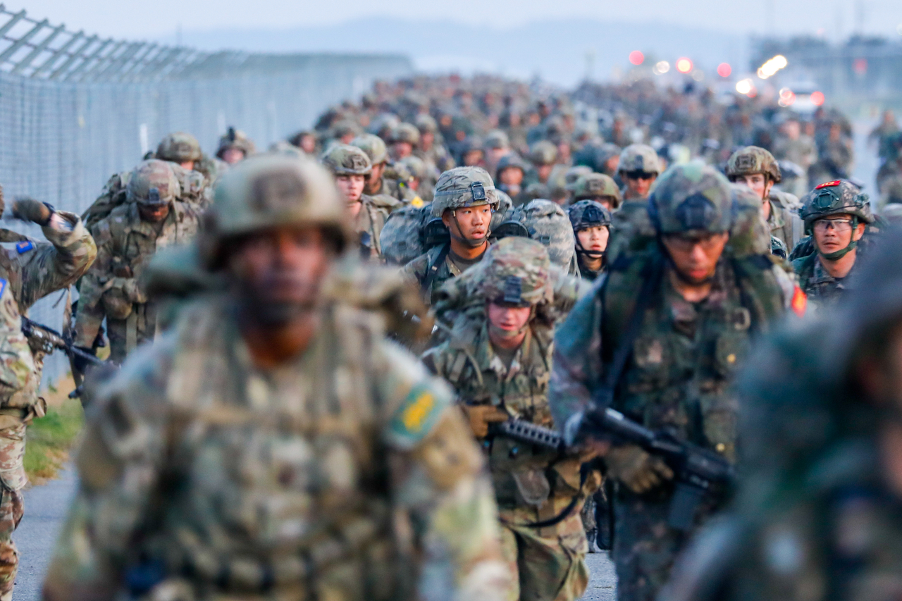 US and South Korean soldiers participate in a 12-mile ruck march as they work to earn an Expert Infantry, Soldier, or Field Medical Badge at Camp Humphreys, South Korea, April 25, 2025.  (US Army)