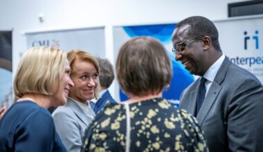 Three people standing and talking