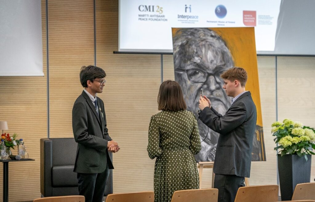 Three people standing and talking