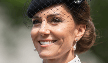 Kate Middleton wearing a white polka dot dress and black hat with a veil