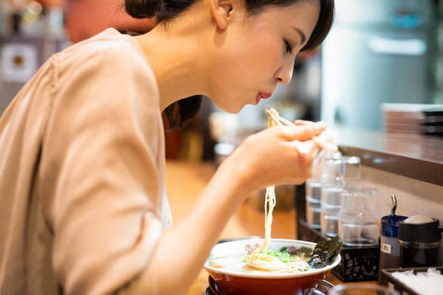 Woman eating ramen