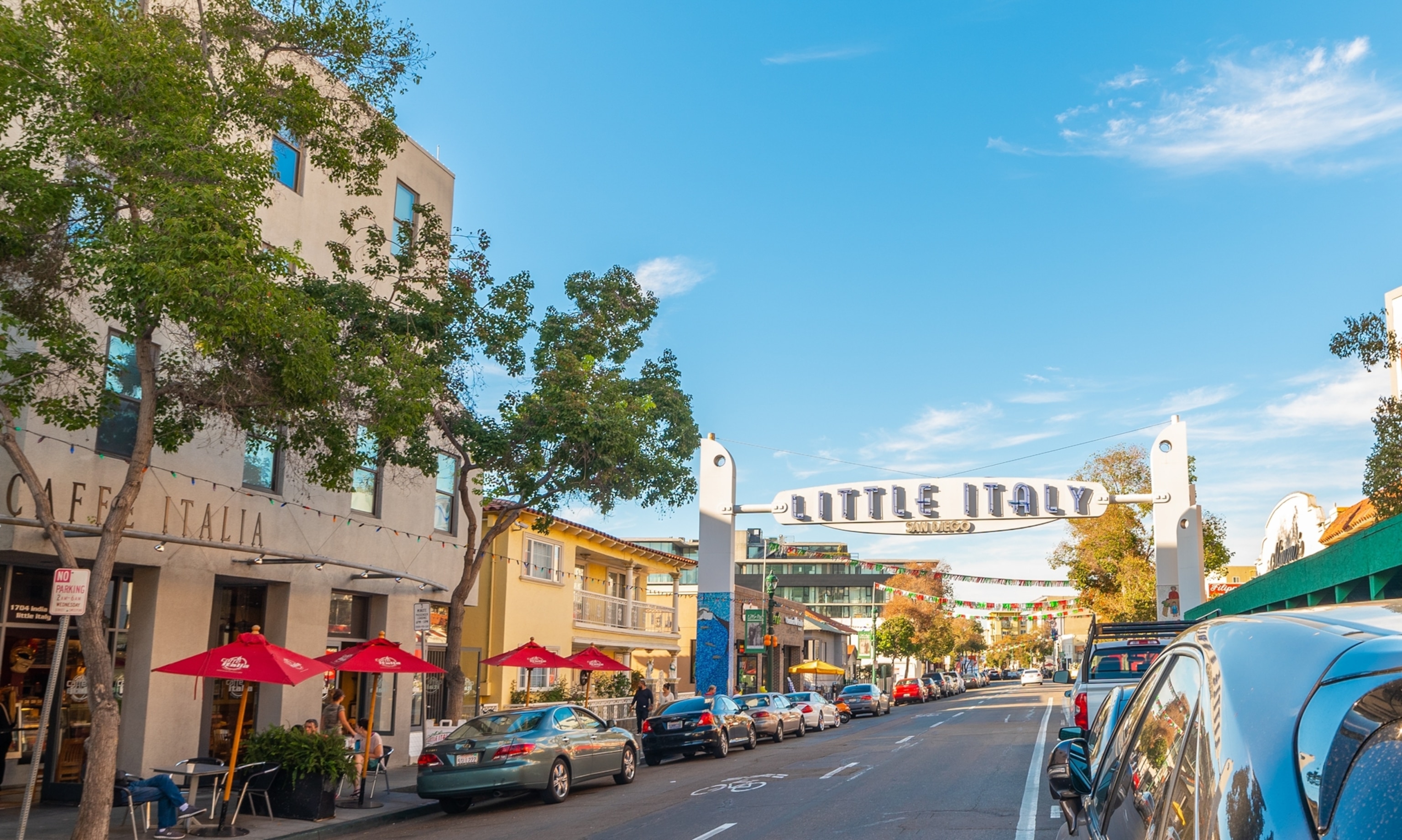 A banner that says Little Italy under a blue sky.