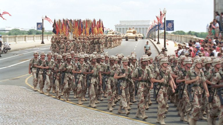Troops march over the Memorial Bridge in Washington, D.C., as they head towards the Pentagon during the National Victory Day Parade on Satur