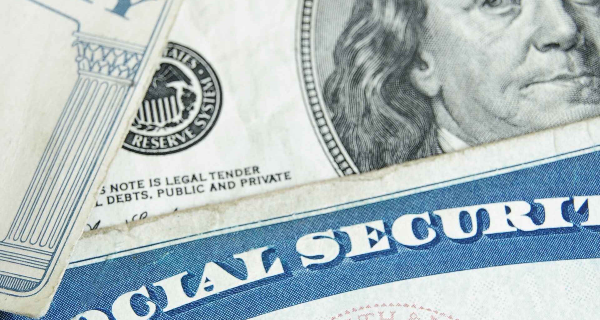 Social Security card atop $100 bill illustrating the six-figure salary needed for 2025’s $5,108 maximum benefit.