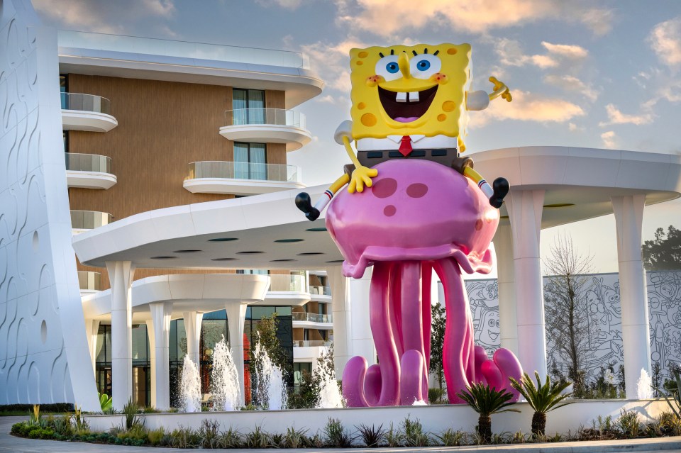 SpongeBob SquarePants statue sitting on a jellyfish at a hotel entrance.