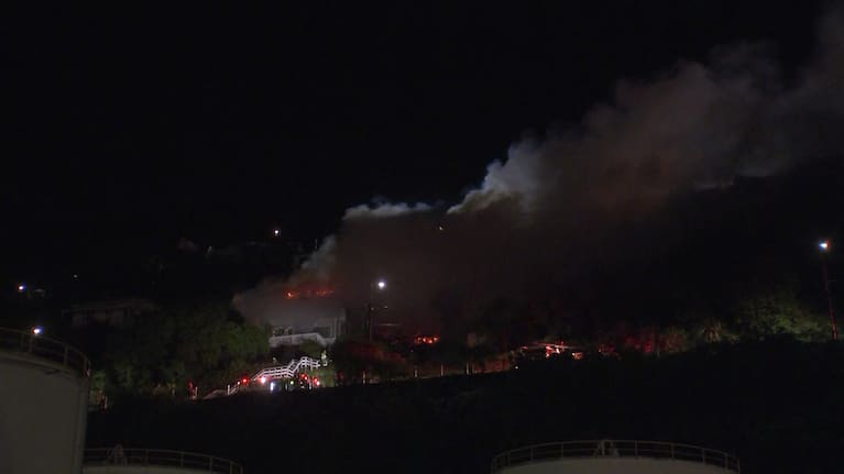 Thick smoke billows from a large fire engulfing two houses in Christchurch.
