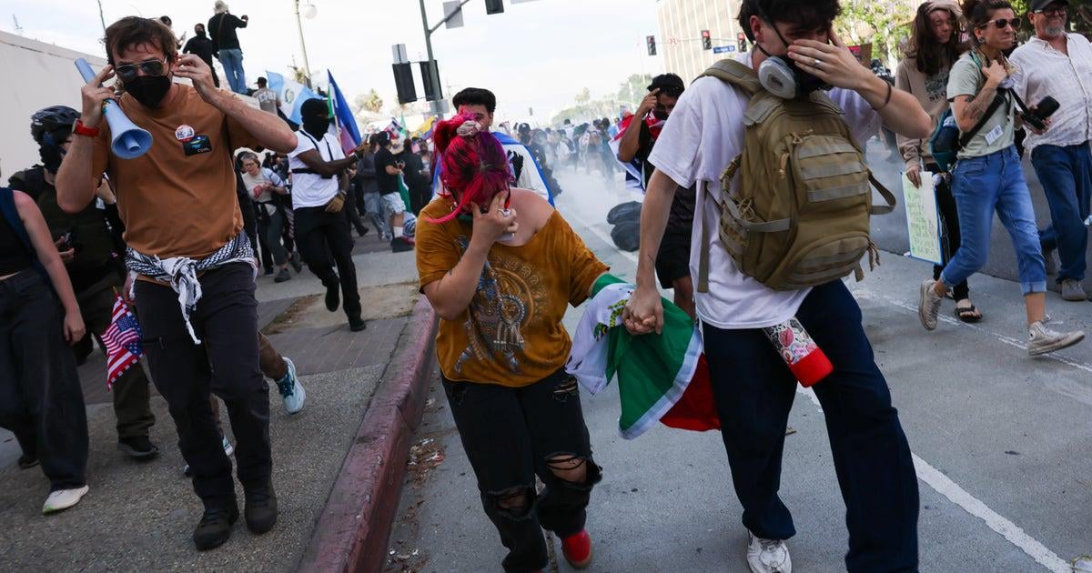 L.A. police use tear gas, flash-bangs on "No Kings" protesters in downtown