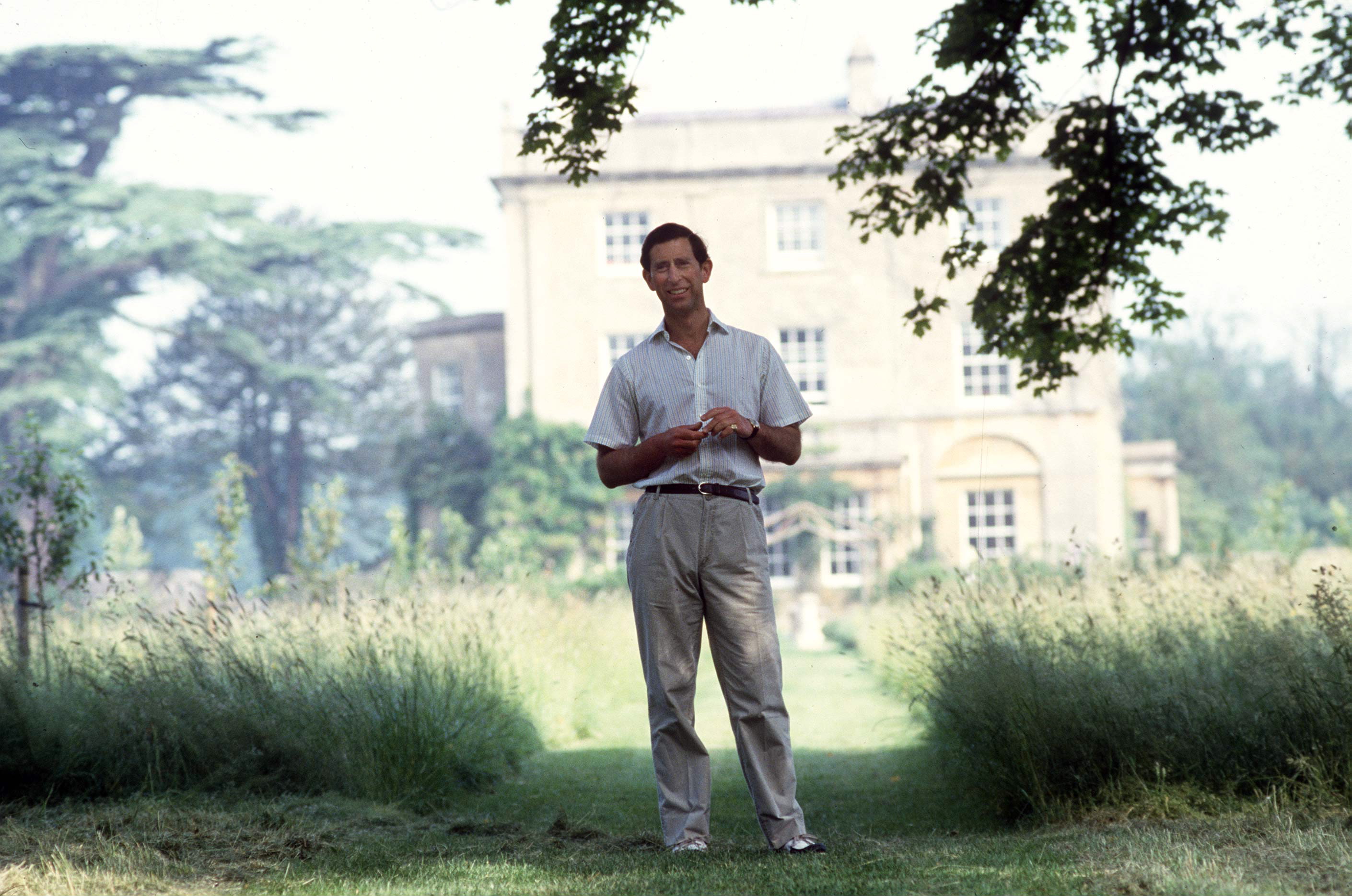 Prince Charles standing outside Highgrove House.