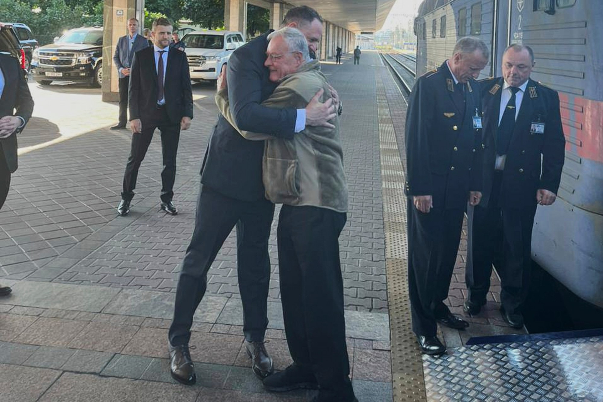 Andriy Yermak and Joseph Keith Kellogg embracing at a train station in Kyiv.