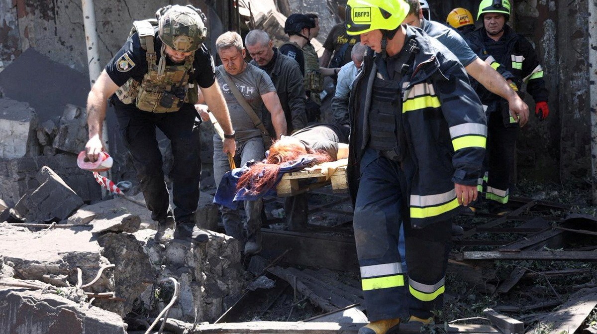 Rescuers carry an injured woman from a damaged building in Dnipropetrovsk region, Ukraine.