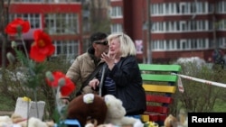 A woman mourns at the site of a Russian missile strike that killed multiple children and adults in a residential area of Kryviy Rih, April 5, 2025.