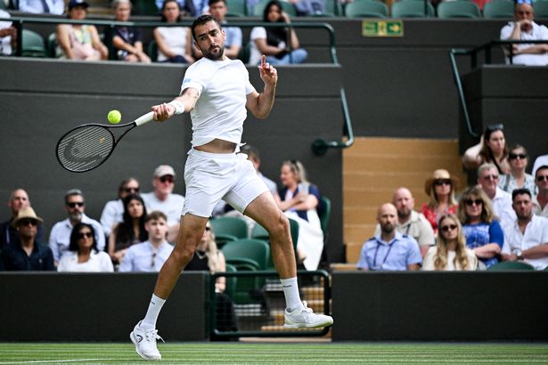 Croatia's Marin Cilic plays a forehand return to Britain's Jack Draper during their men's singles second round tennis match on the fourth day of the 2025 Wimbledon Championships at The All England Lawn Tennis and Croquet Club in Wimbledon, southwest London, on July 3, 2025. (Photo by Kirill KUDRYAVTSEV / AFP) / RESTRICTED TO EDITORIAL USE (Photo by KIRILL KUDRYAVTSEV/AFP via Getty Images)