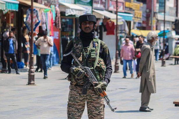 An Indian paramilitary soldier stands guard along a road in Srinagar, Jammu and Kashmir, on May 15, 2025. Indian Defence Minister Rajnath Singh says on May 15 that Pakistan's nuclear arsenal should be under the surveillance of the UN's nuclear agency, following last week's four days of conflict between Islamabad and New Delhi. (Photo by Firdous Nazir/NurPhoto via Getty Images)
