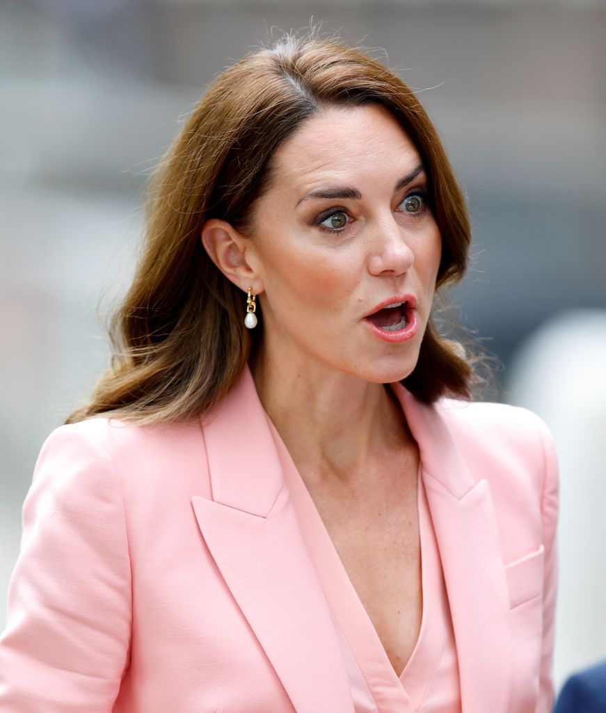 Catherine mouth open in peach suit