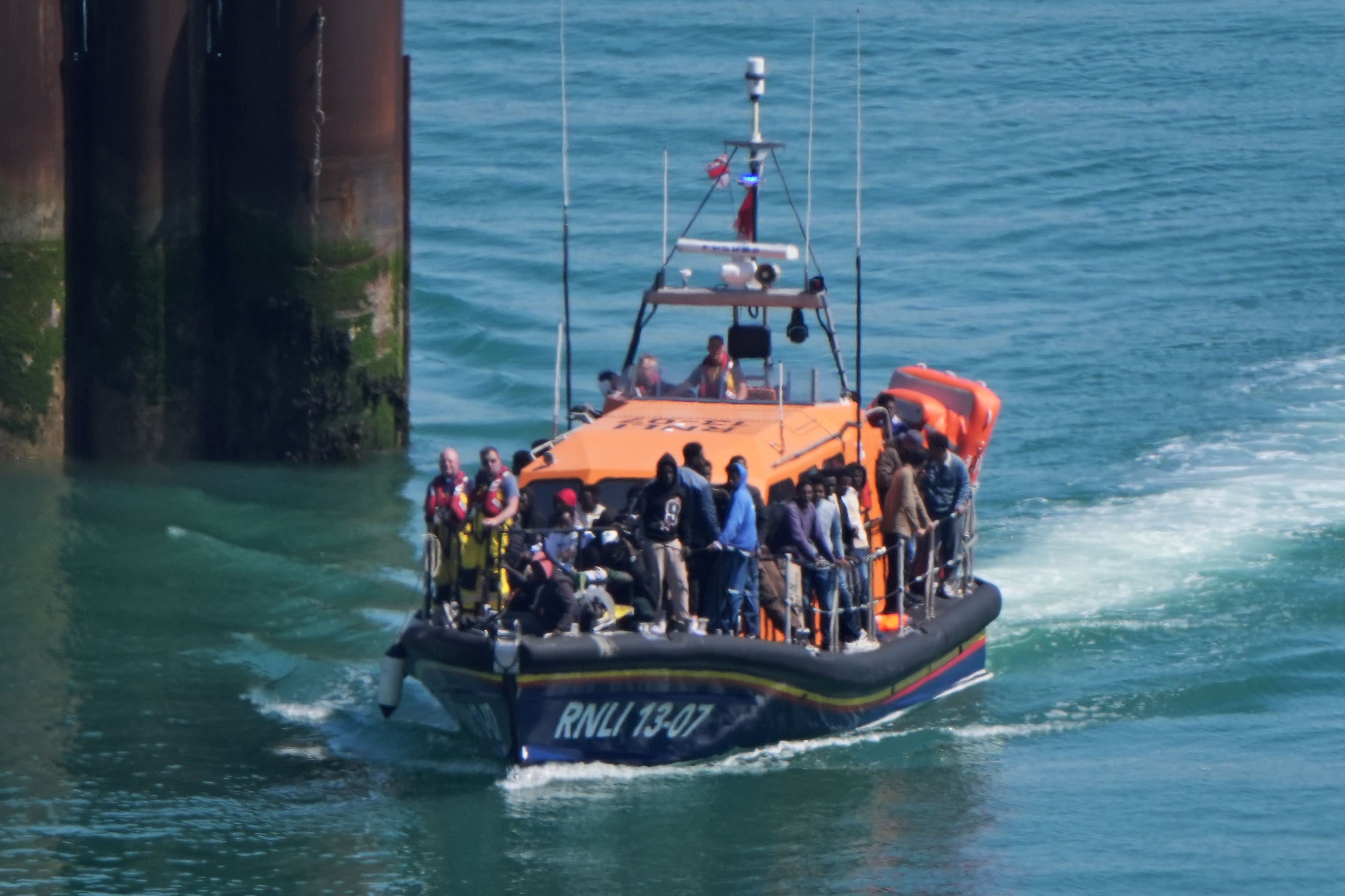 A group of people thought to be migrants are brought in to Dover, Kent, onboard an RNLI Lifeboat on Thursday