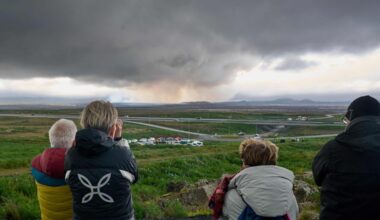 Tourists watching smoke and lava emanating from a volcano on Iceland's Reykjanes peninsula on July 16.