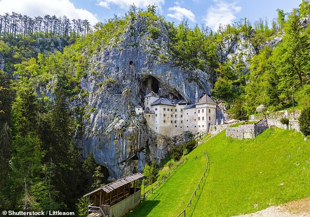 Predjama Castle, set into the mountainside, is a few miles away from Postojna