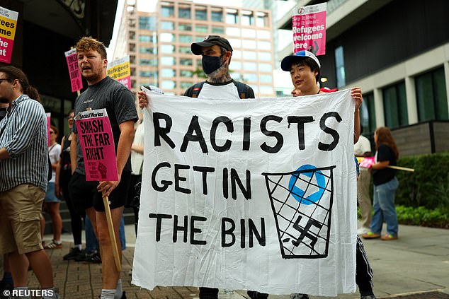 Pro-migrant protesters gathered in their droves outside the Canary Wharf hotel