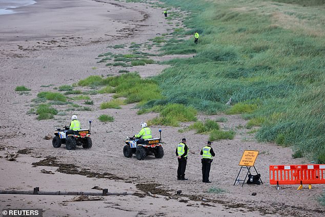 Members of the police stand at a beach near Trump Turnberry resort, during Trump's visit to Scotland, today