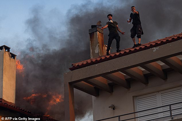 Locals desperately attempt to escape a burning house in Kryoneri, near Athens