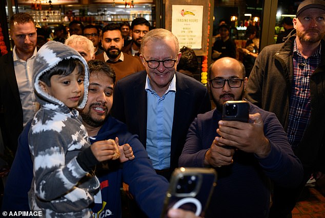 Australia's record immigration has been likened to a Ponzi scheme as a new report reveals international students are worsening the housing crisis (pictured is Prime Minister Anthony Albanese in Parramatta in western Sydney)