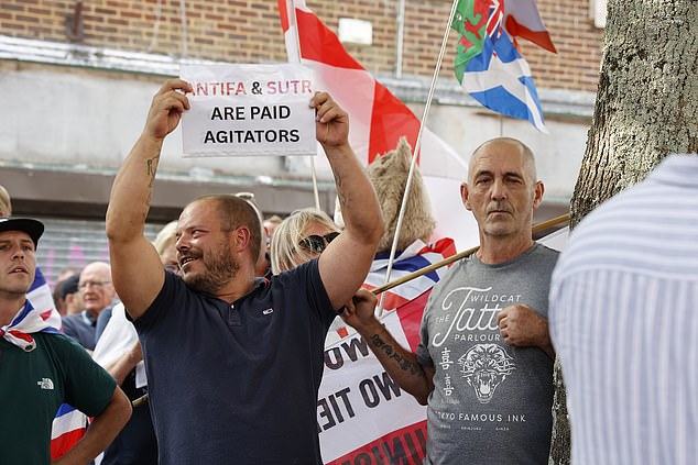 Protestors gather in Waterlooville high street protesting against migrant housing in the town centre