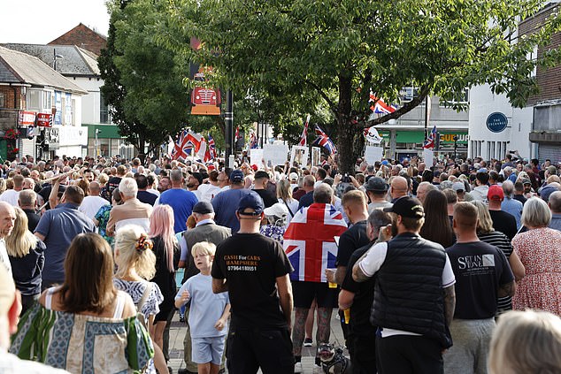 An Epping-style protest to stop migrants being housed above a town's high street shops is underway - as thousands of locals warn of 'mayhem' if the plans go ahead