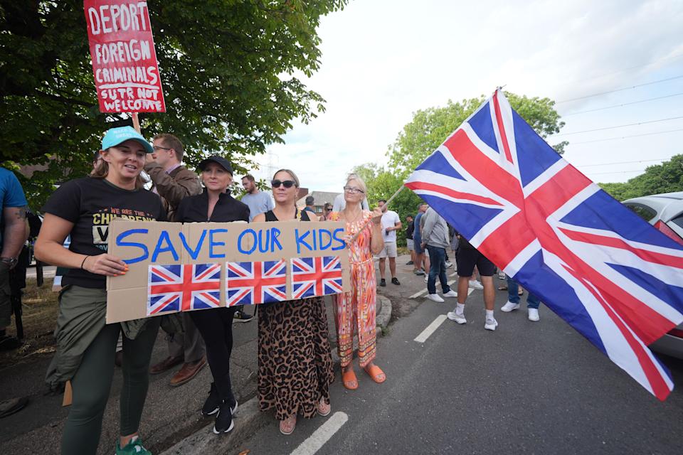 Protesters outside the Bell Hotel in Epping, Essex. There have been a number of demonstrations outside the hotel, believed to be housing asylum seekers, since police charged 38-year-old asylum seeker Hadush Gerberslasie Kebatu with sexual assault following an incident where he is alleged to have attempted to kiss a 14-year-old girl. Picture date: Sunday July 20, 2025.