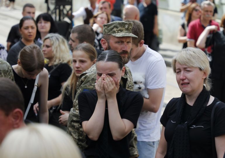 epa12261796 People react during a farewell ceremony for twelve Ukrainian soldiers who died in Russian captivity, in Lviv, Ukraine, 25 July 2025, amid the ongoing Russian invasion. The soldiers were part of the 24th Mechanized Brigade, and were killed in January 2024, according to the Lviv City Council. EPA/MYKOLA TYS