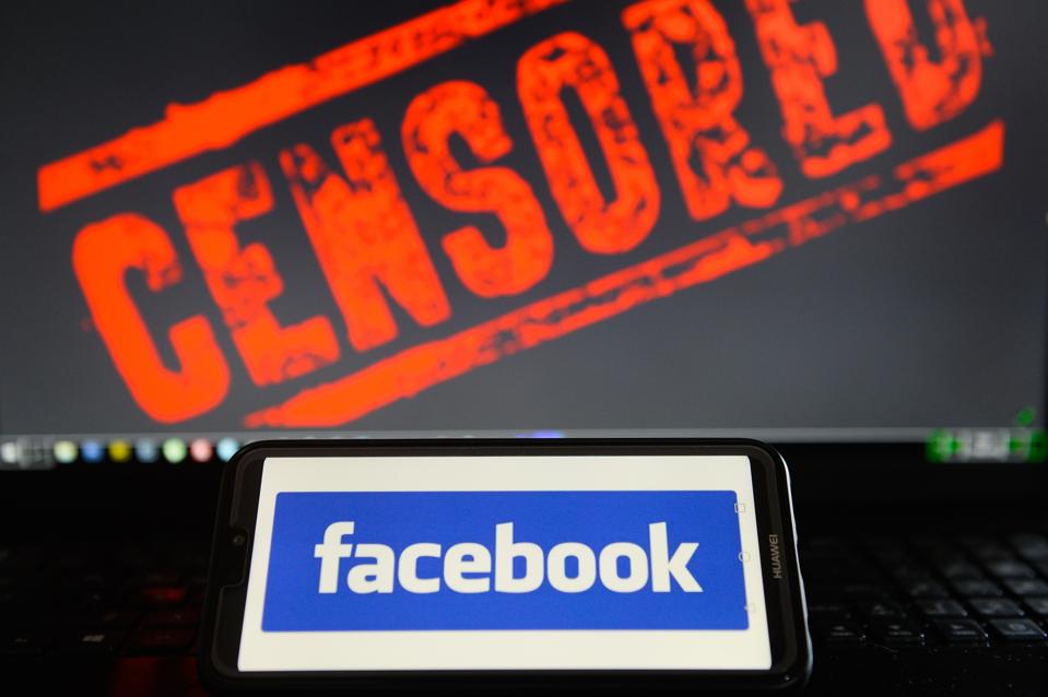 Facebook logo is seen on a Huawei smart phone with the word