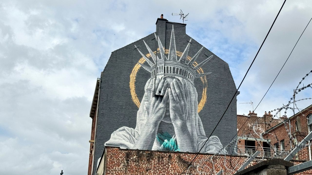 A new mural in France shows the Statue of Liberty covering her eyes in a swipe at Trump