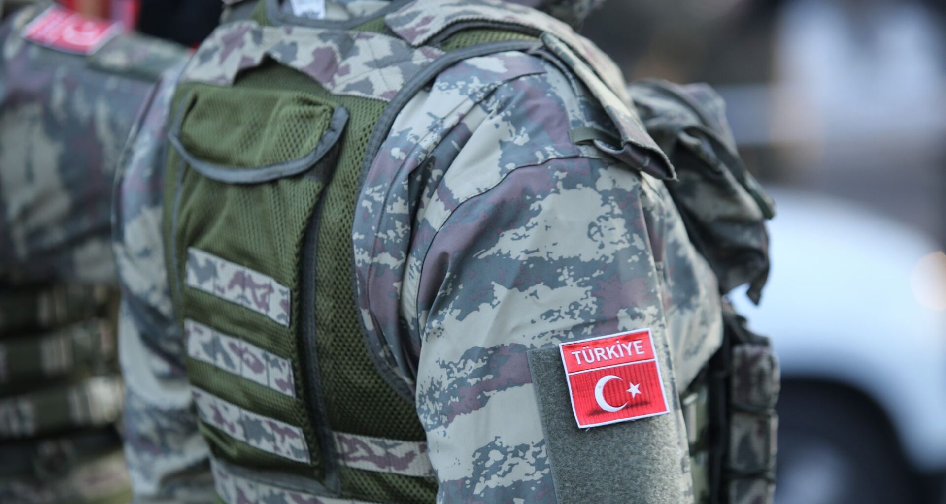 The side of a person in Turkish military fatigues.