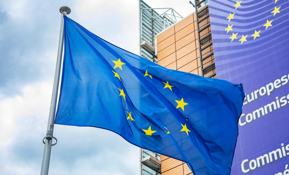 European Union flag in front of the Berlaymont building, headquarters of European Commission.