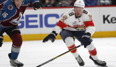 Former Florida Panthers centre Jayce Hawryluk, right, reaches out to control the puck as Colorado Avalanche defenceman Nikita Zadorov pursues during a National Hockey League game on Feb. 25, 2019 in Denver. Hawryluk now plies his trade in Europe. (Associated Press)