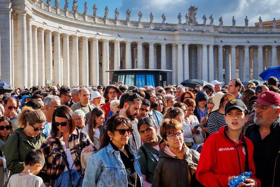 Crowd of faithful in St. Peter's Square,, line up to enter the Basilica. 