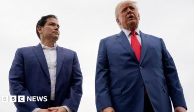 Marco Rubio in blue blazer and white shirt next to Trump in blue suit with red tie
