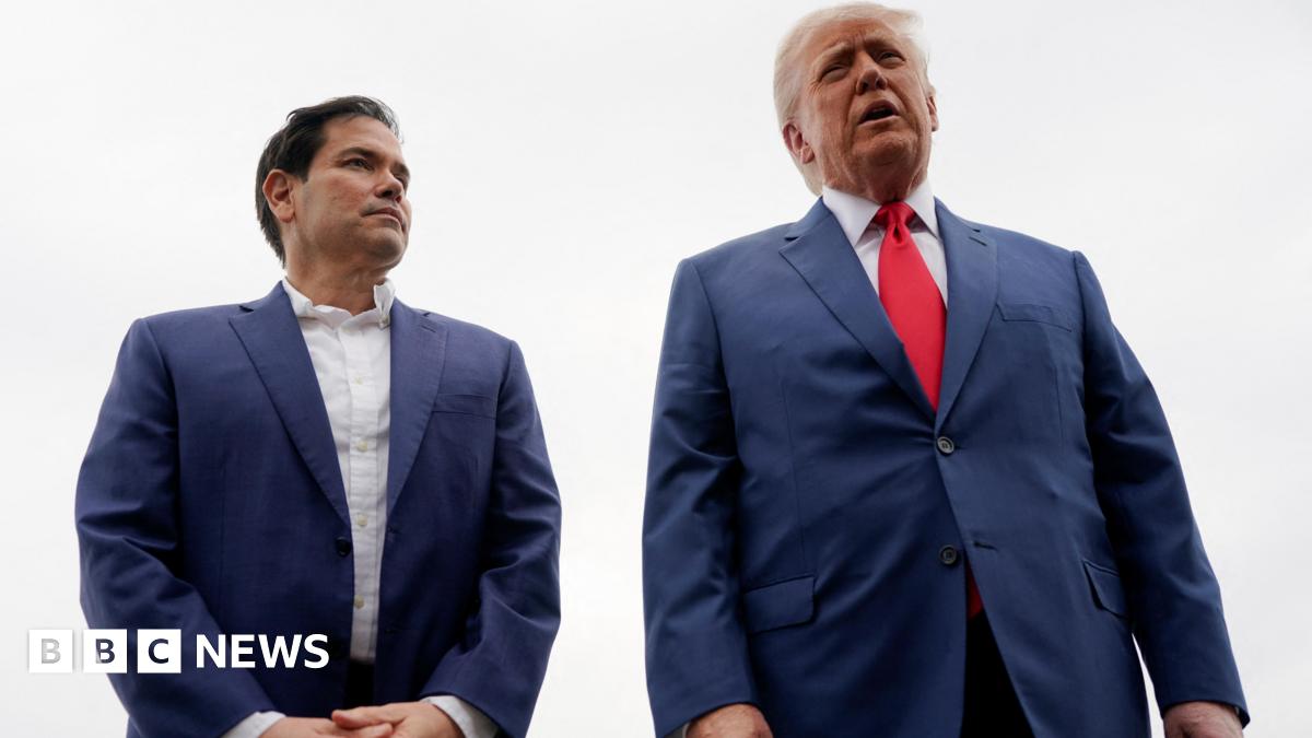 Marco Rubio in blue blazer and white shirt next to Trump in blue suit with red tie