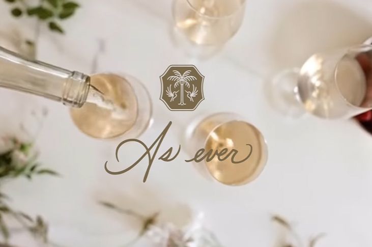 A bottle of wine pouring into a wine glass