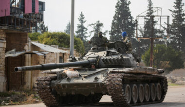 Rebels led by the Islamist militant group Hayat Tahrir al-Sham drive a military vehicle in al-Rashideen