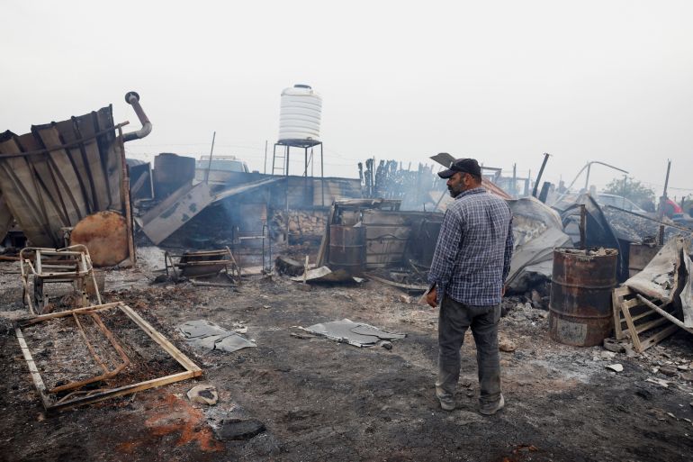 A Palestinian inspects the damage after an attack by Israeli settlers, in Sinjil, near Ramallah, in the Israeli-occupied West Bank April 23, 2025. REUTERS/Mohammed Torokman