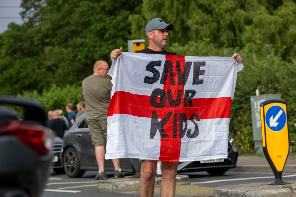 Protestor holding a flag that says "Save Our Kids".