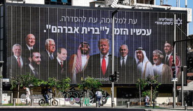 A billboard with the Hebrew slogan "a time for war, a time for settlement; now is the time for the 'Abrahamic Covenant'" is displayed in Tel Aviv on June 26, 2025