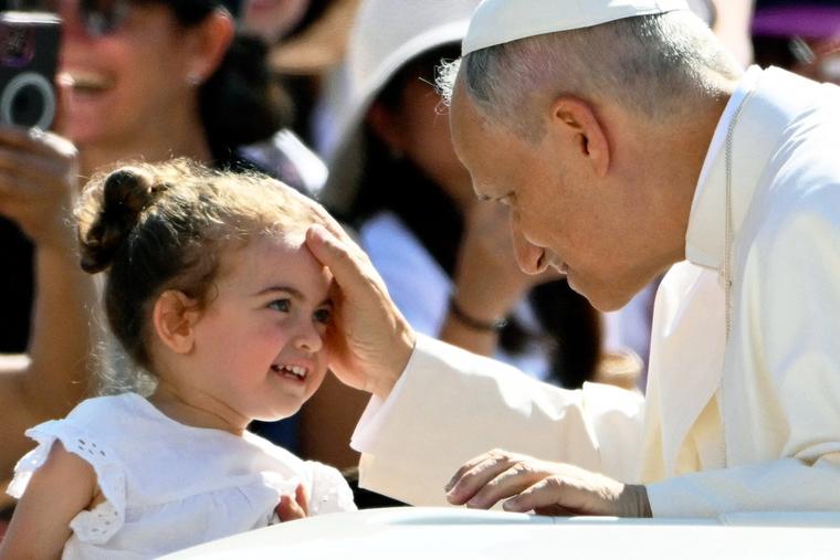Pope Leo XIV blesses a little girl during the June 25 general audience in St. Peter's Square.