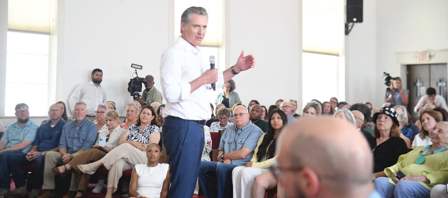 Gavin Newsom addresses a capacity crowd at St. Paul Baptist Church in Laurens on July 9, as part of a whirlwind tour of small South Carolina cities.