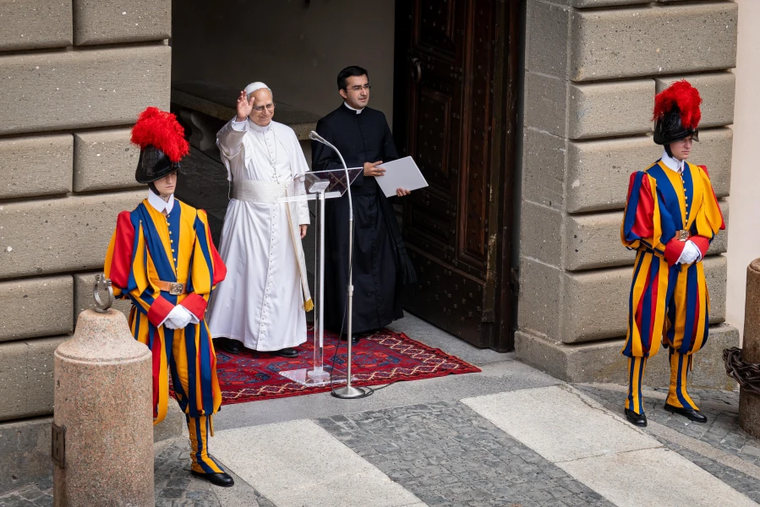 Pope Leo XIV waves as he enters Liberty Square in Castel Gandolfo to give his first public Angelus address from the lakeside town 18 miles southeast of Rome on July 13, 2025.