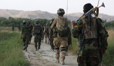 A British army officer patrols with Afghan soldiers in Sangin Valley, Helmand Province, Afghanistan, June 2007