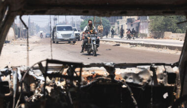 Bedouin fighters cross the al-Mazraa village in Syria's Suwayda governorate